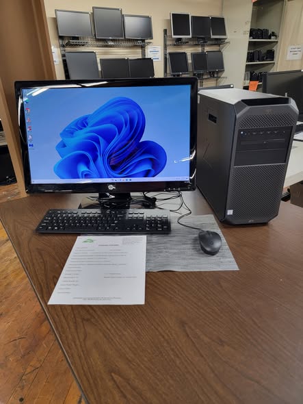 Desktop computer, monitor, keyboard and mouse on a shop table